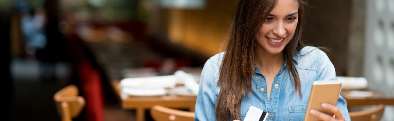 Woman smiling, looking at phone